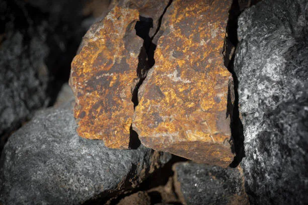 Close up outdoor view of stone on the ground. Piece of orange rocky stone. Beautiful texture. Selective focus.
