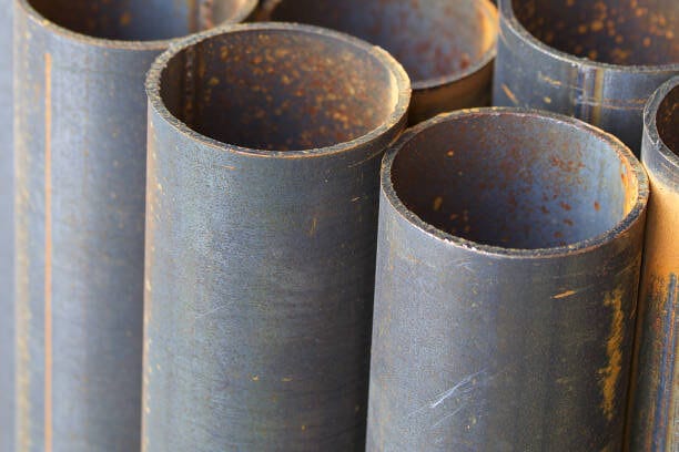 Metal profile pipe of round section in packs at the warehouse of metal products, Russia