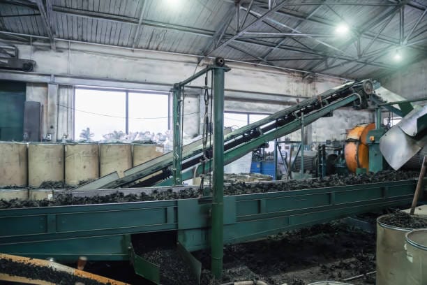 Rubber recycling processing factory, industrial equipment and conveyor line with cut used car tires. Recycling waste.